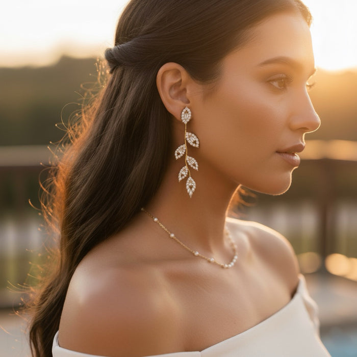 Woman wearing elegant earrings and a necklace with a blurred outdoor background