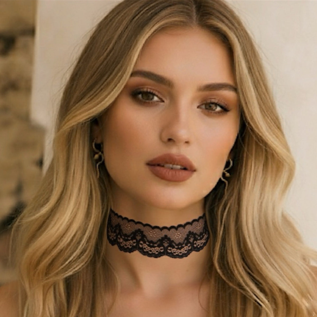 Woman wearing a black lace choker with a neutral background