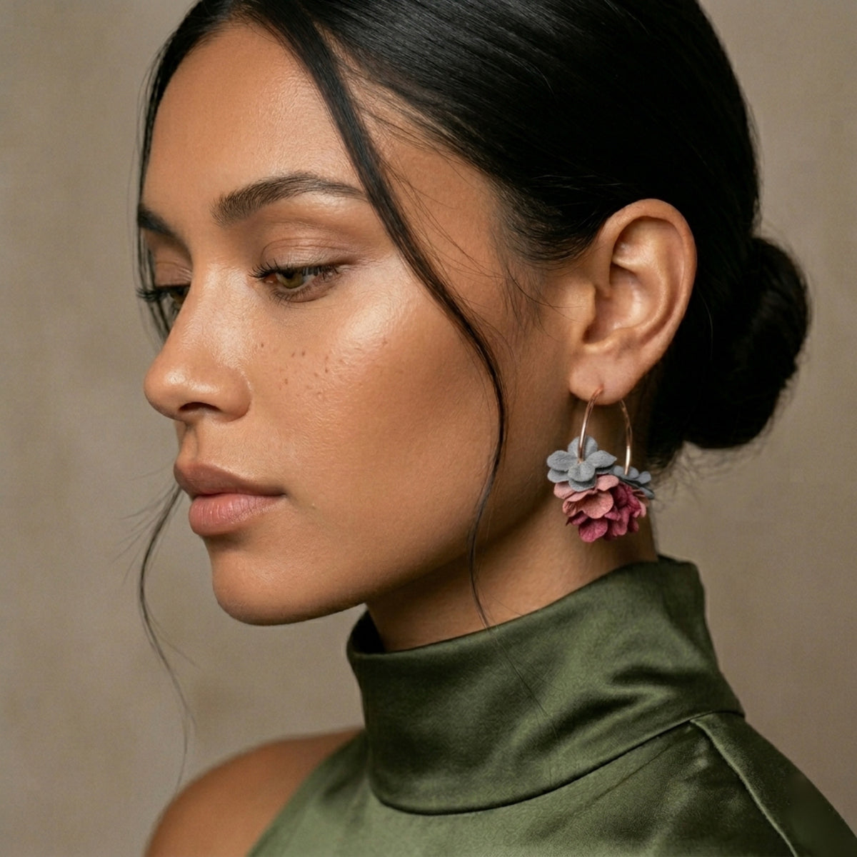 Woman wearing colorful floral earrings against a neutral background. Anielle Flower Hoops Earrings - The Songbird Collection I