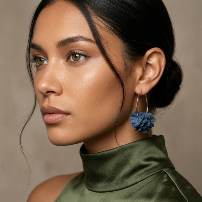Woman wearing blue floral earrings with a neutral background. Anielle Flower Hoops Earrings - The Songbird Collection I