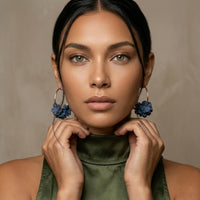 Woman wearing large hoop earrings with floral accents against a neutral background. Anielle Flower Hoops Earrings - The Songbird Collection I