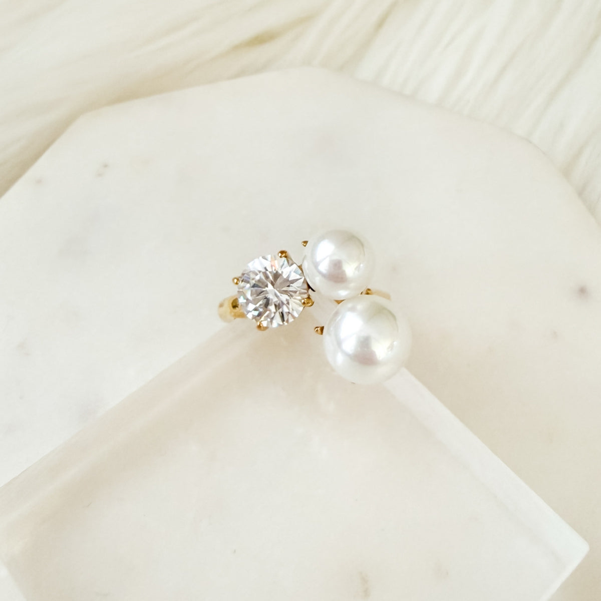 Pearl and diamond earring on a white surface