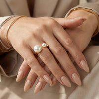 Hand wearing a pearl ring with a neutral background - Arista Open Pearl Ring - stainless steel - The Songbird Collection