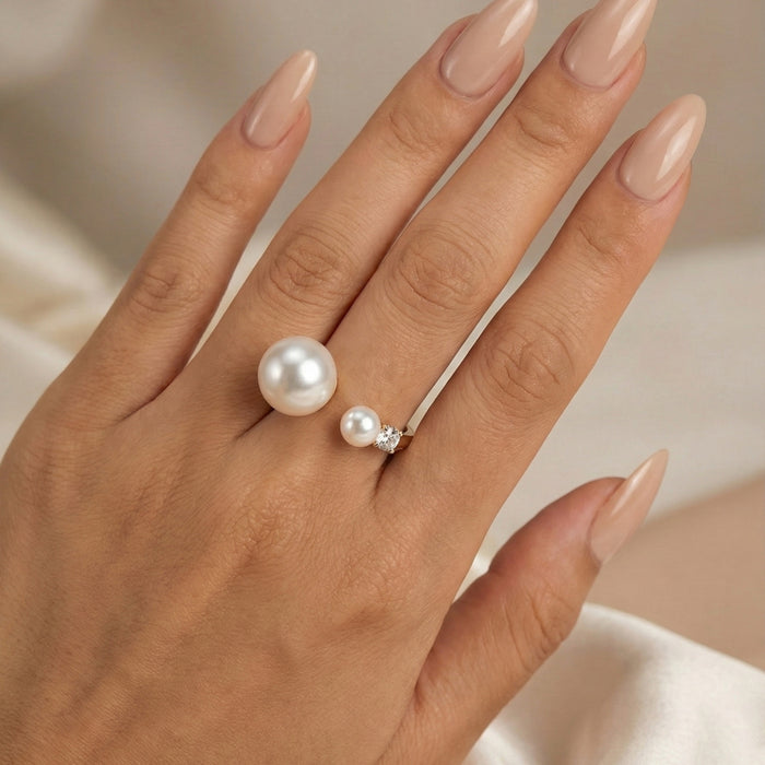 Hand wearing two pearl rings on a neutral background  Arista Open Pearl Ring - stainless steel - The Songbird Collection