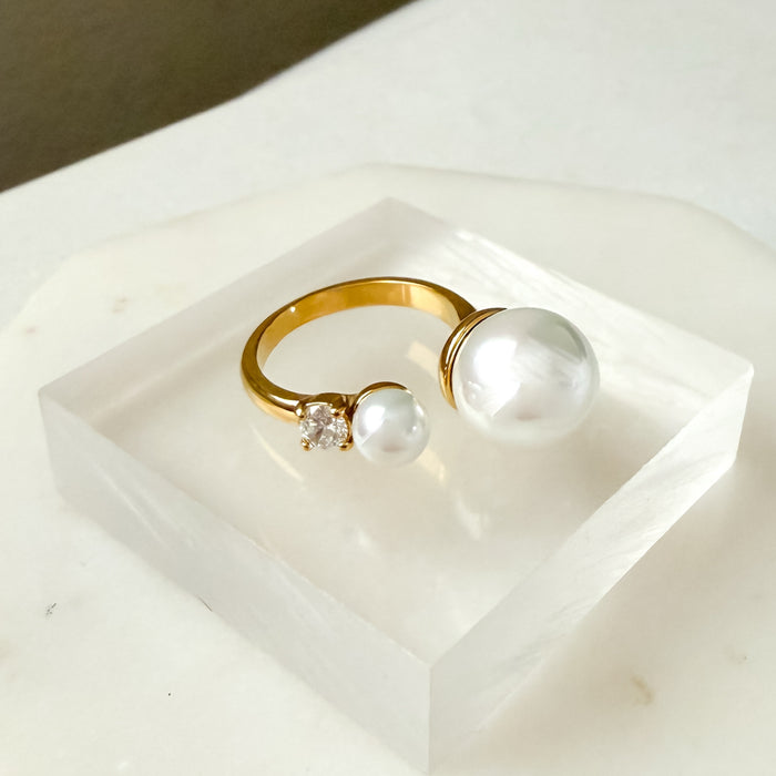 Gold ring with pearls and a diamond on a white stand  Arista Open Pearl Ring - stainless steel - The Songbird Collection
