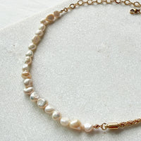 Pearl necklace with gold clasp on a light background  Ashlyn Freshwater Pearl Necklace - The Songbird Collection