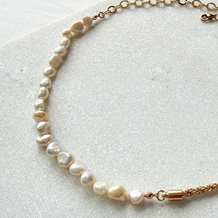 Pearl necklace with gold clasp on a light background  Ashlyn Freshwater Pearl Necklace - The Songbird Collection