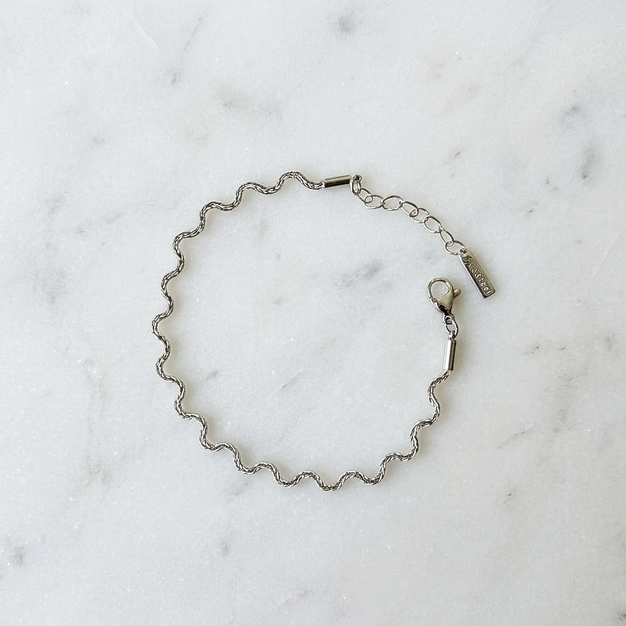 Silver chain bracelet on a marble surface - Aura_Ripple_Chain_Bracelet_-_The_Songbird_Collection 