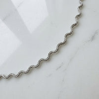 Silver wavy chain on a marble surface - Aura_Ripple_Chain_Bracelet_-_The_Songbird_Collection