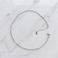 stainless steel silver wavy chain necklace a marble surface - Aura_Ripple_Chain_Necklace_-_The_Songbird_Collection