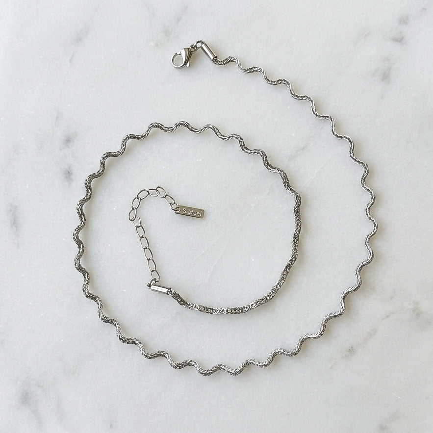 stainless steel silver wavy chain necklace a marble surface - Aura_Ripple_Chain_Necklace_-_The_Songbird_Collection