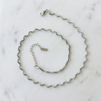 stainless steel silver wavy chain necklace a marble surface - Aura_Ripple_Chain_Necklace_-_The_Songbird_Collection