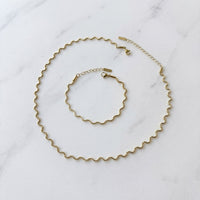 Gold necklace and bracelet set on a marble surface - Aura Ripple  WAVY Chain Necklace and Bracelet - The Songbird Collection