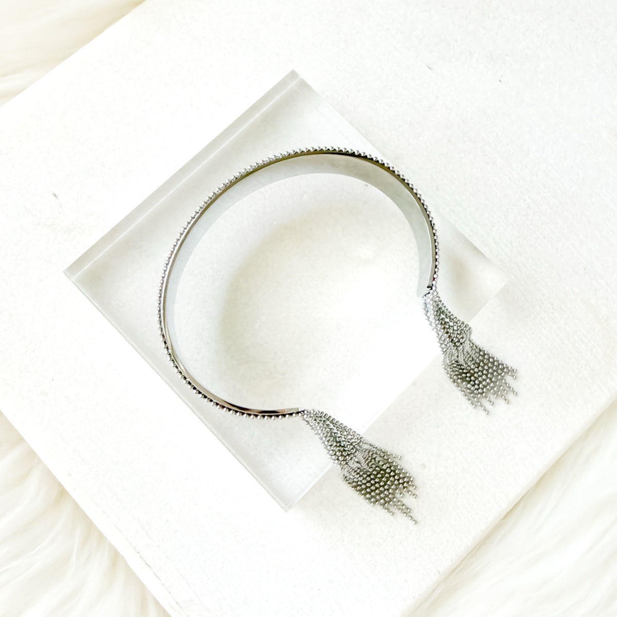 bracelet with tassels on a white surface