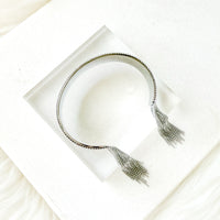 bracelet with tassels on a white surface