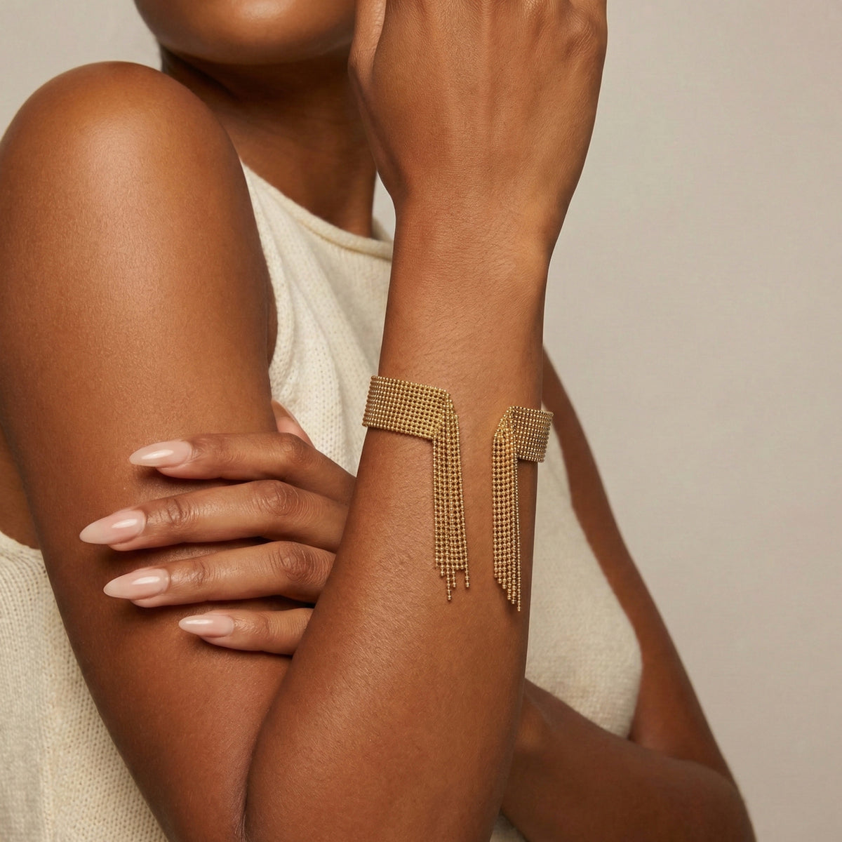 Gold arm cuff on a person's arm with a neutral background - Beaded_Fringe_Statement_Bracelet_Cuff_-_The_Songbird_Collection