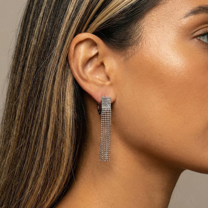 Close-up of a woman wearing Beaded Fringe Statement Earrings - The Songbird Collection with a neutral background