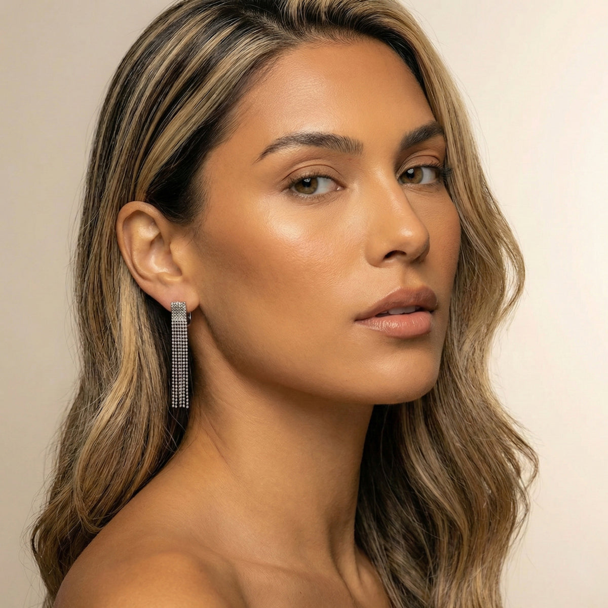 Woman wearing a silver earring with a neutral background - Beaded Fringe Statement Earrings - The Songbird Collection