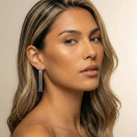 Woman wearing a silver earring with a neutral background - Beaded Fringe Statement Earrings - The Songbird Collection