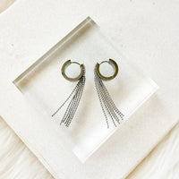 Hoop earrings with chain tassels on a white napkin