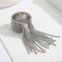 Silver beaded fringe ring on a white background