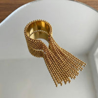 Gold ring with tassel on a white surface Beaded Fringe Statement Ring - The Songbird Collection