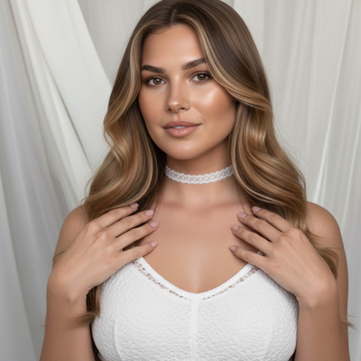 Woman wearing a white lace top and choker against a white curtain background