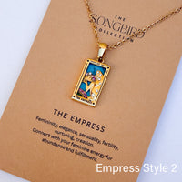Necklace with tarot card pendant labeled 'The Empress' on a brown card with text.