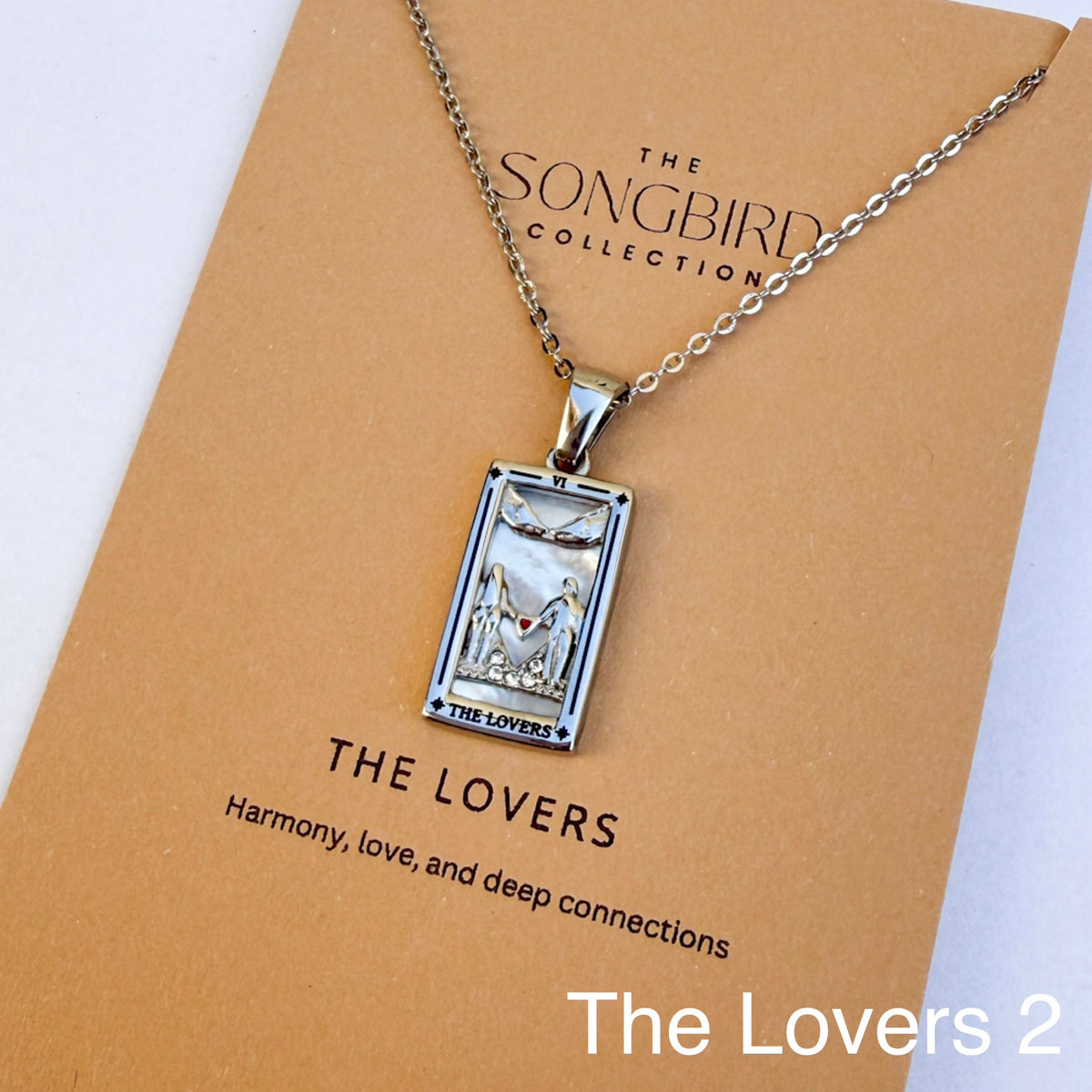 Necklace with a pendant labeled 'The Lovers' on a 'The Songbird Collection' card.