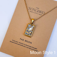 Gold necklace with a pendant on a 'The Songbird Collection' card