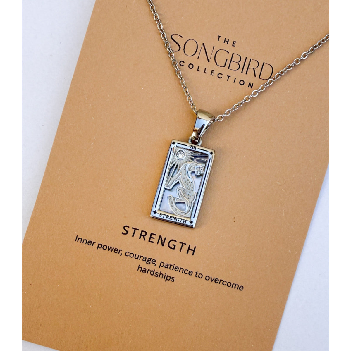 Silver Strength pendant necklace on a 'The Songbird Collection' card with text.