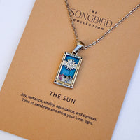 Necklace with 'The Sun' pendant from The Songbird Collection on a brown card.