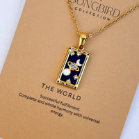 Necklace with 'The World' tarot card pendant on a 'Songbird Collection' card.