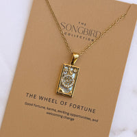 Gold necklace with a pendant on a 'The Songbird Collection' card