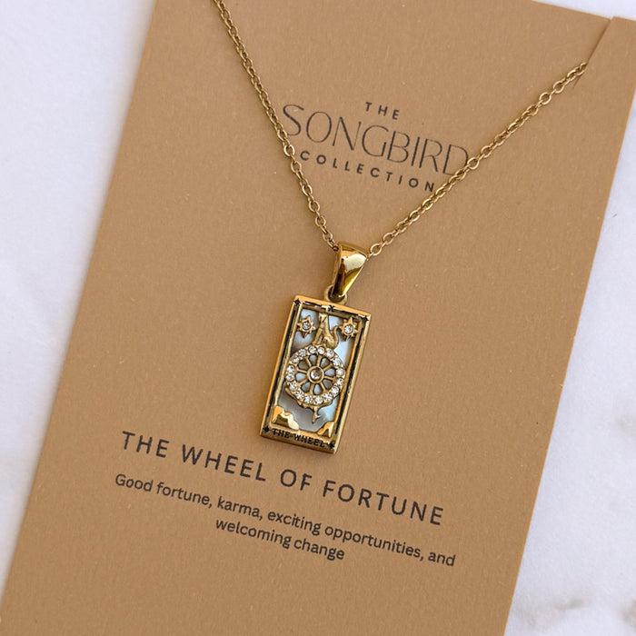 Gold necklace with a pendant on a 'The Songbird Collection' card