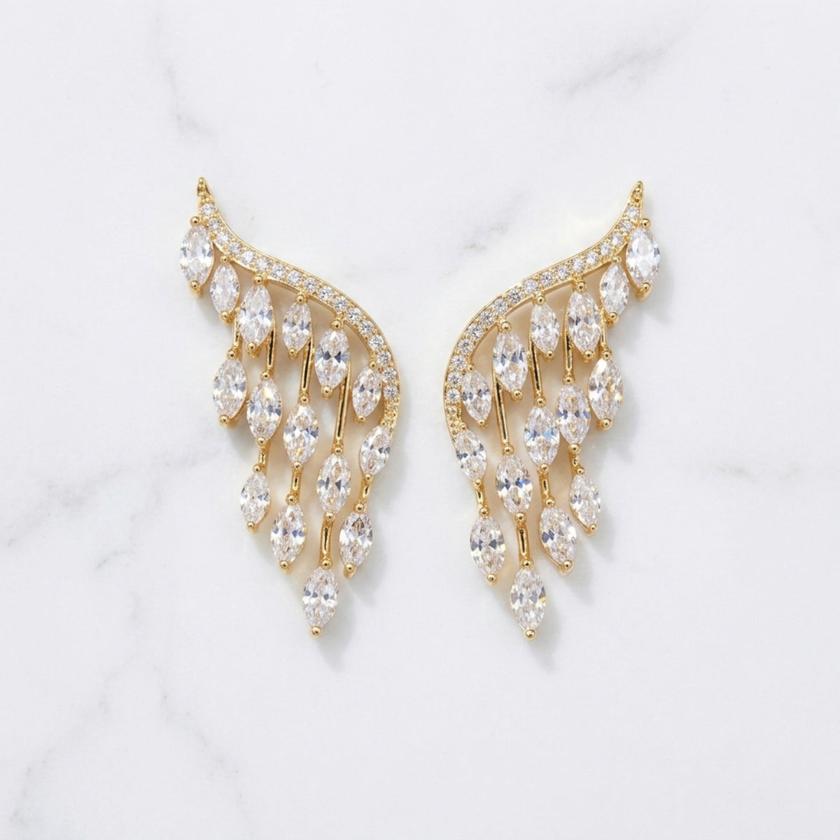 Gold and crystal earrings on a light gray background  Chandelier_Earrings_-_The_Songbird_Collection