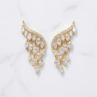 Gold and crystal earrings on a light gray background  Chandelier_Earrings_-_The_Songbird_Collection