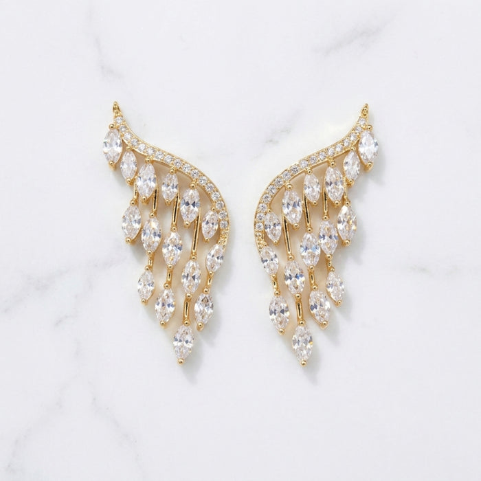 Gold and crystal earrings on a light gray background  Chandelier_Earrings_-_The_Songbird_Collection