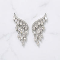 Pair of silver earrings with clear gemstones on a light gray background  Chandelier_Earrings_-_The_Songbird_Collection