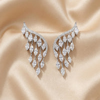Pair of diamond earrings on a be  ige satin background. Chandelier_Earrings_-_The_Songbird_Collection