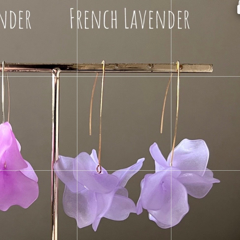 Purple flower earrings on a stand with 'French Lavender' text on a gray background