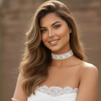 Woman wearing a white lace choker and dress with a blurred background