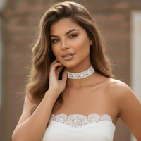 Woman wearing a white lace choker and  dress with a blurred background