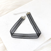 Black mesh lace choker necklace on a white surface
