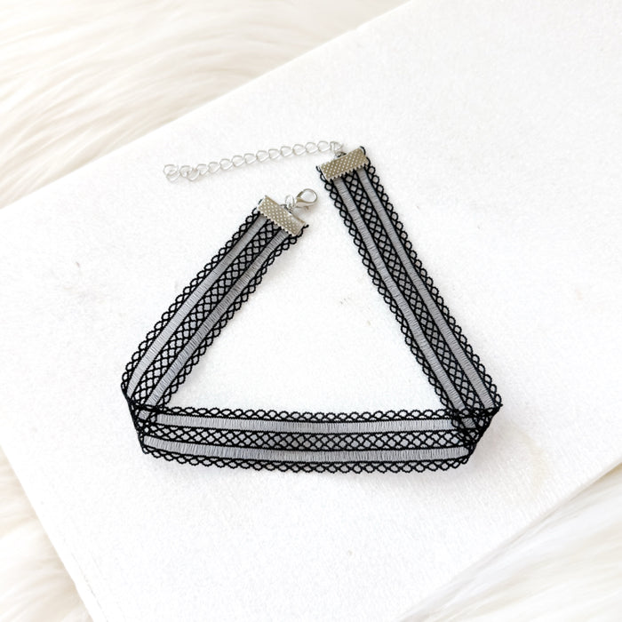 Black mesh lace choker necklace on a white surface