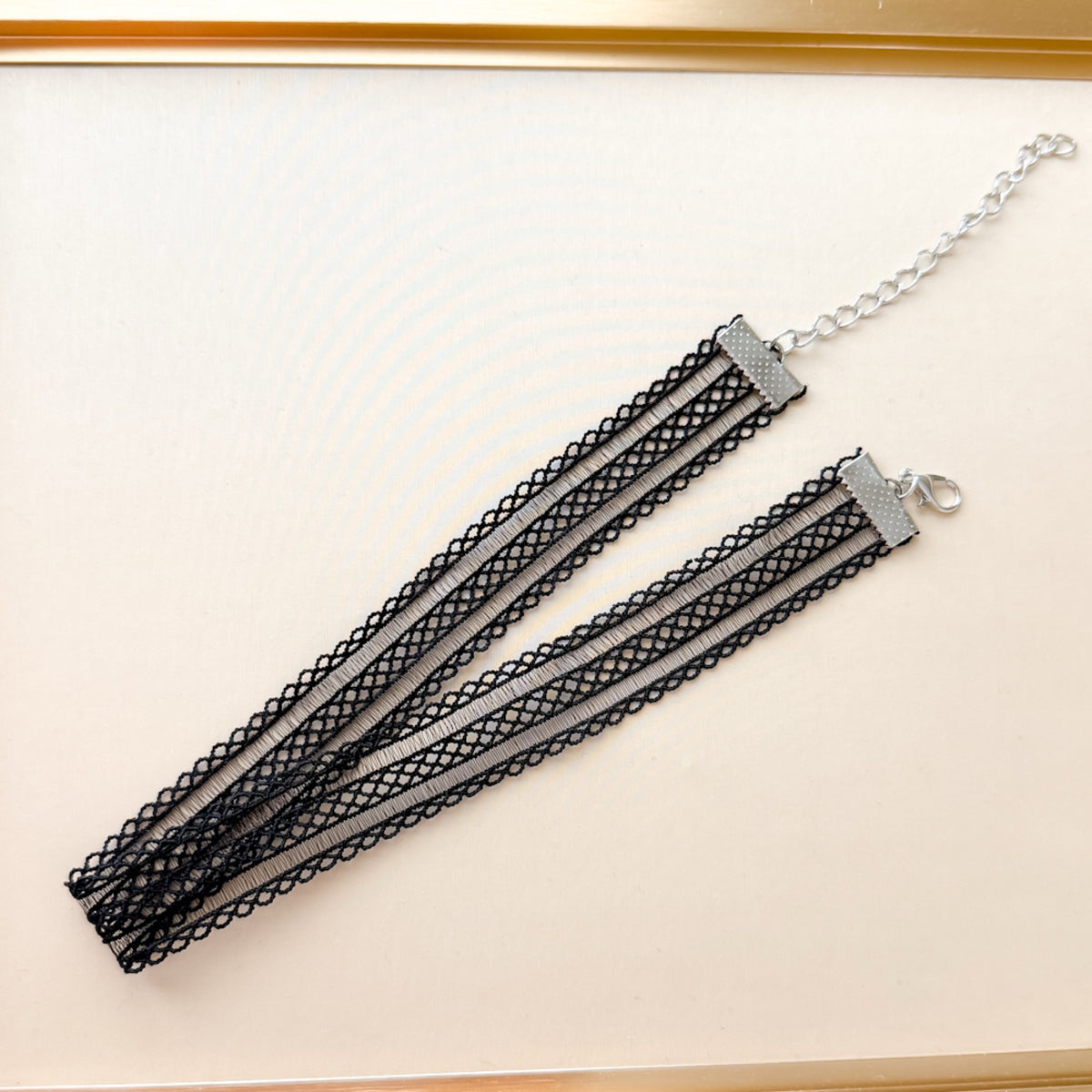 Black lace choker necklace on a white background