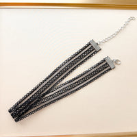 Black lace choker necklace on a white background
