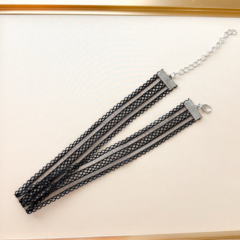Black lace choker necklace on a white background