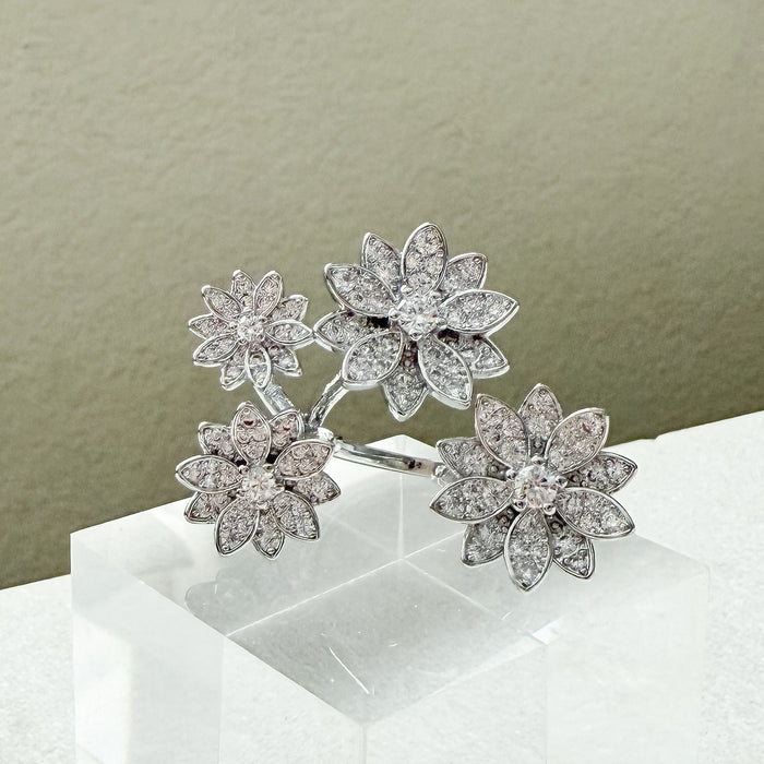 Floral diamond earrings on a white stand with a neutral background