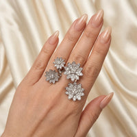 Silver floral ring on a hand with a beige satin background - Enchanted Garden Between the Finger Ring - The Songbird Collection